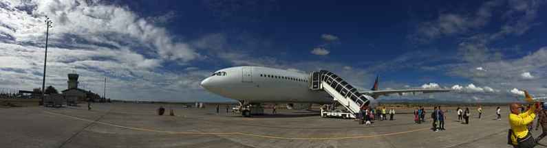 Airport view of a plane loading passengers
